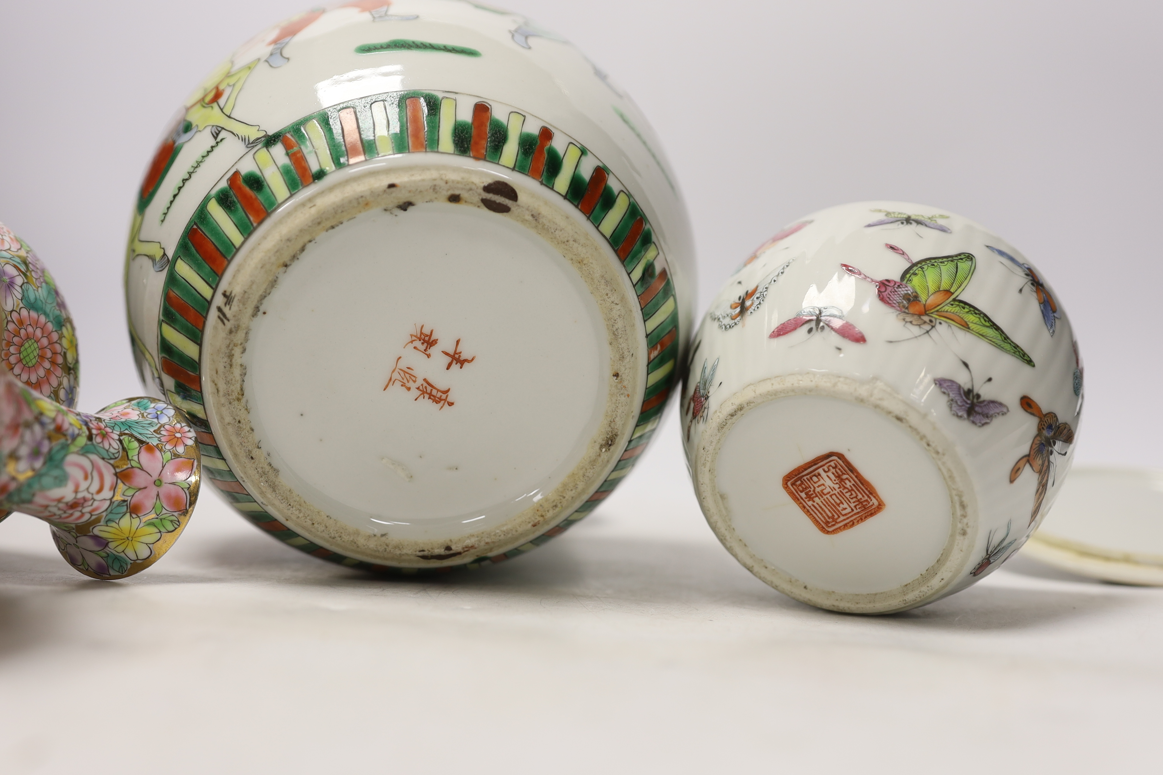 A Chinese famille rose 'butterfly' bowl and cover, Tongzhi mark and period, a famille verte jar and a pair of millefleur vases, tallest 19cm (4)